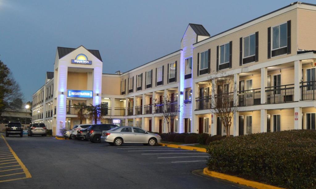 a parking lot in front of a large building at Days Inn by Wyndham Marietta-Atlanta-Delk Road in Marietta
