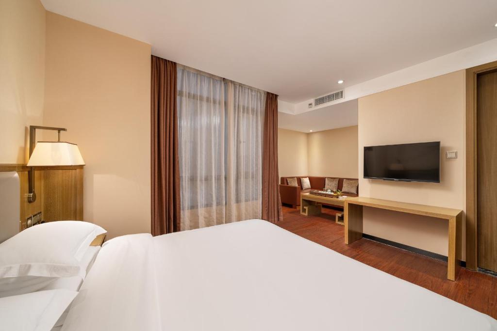 TV a/nebo společenská místnost v ubytování Guangzhou Boyi Hotel