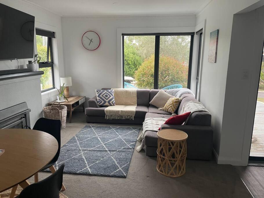 a living room with a couch and a table at Little White House on Ecclestone, Riverside in Alanvale