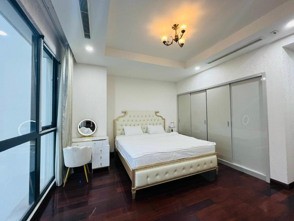 a bedroom with a bed and a dresser and a window at Vinhomes Royal City 72 Nguyễn Trãi Thanh Xuân Hà Nội in Hanoi