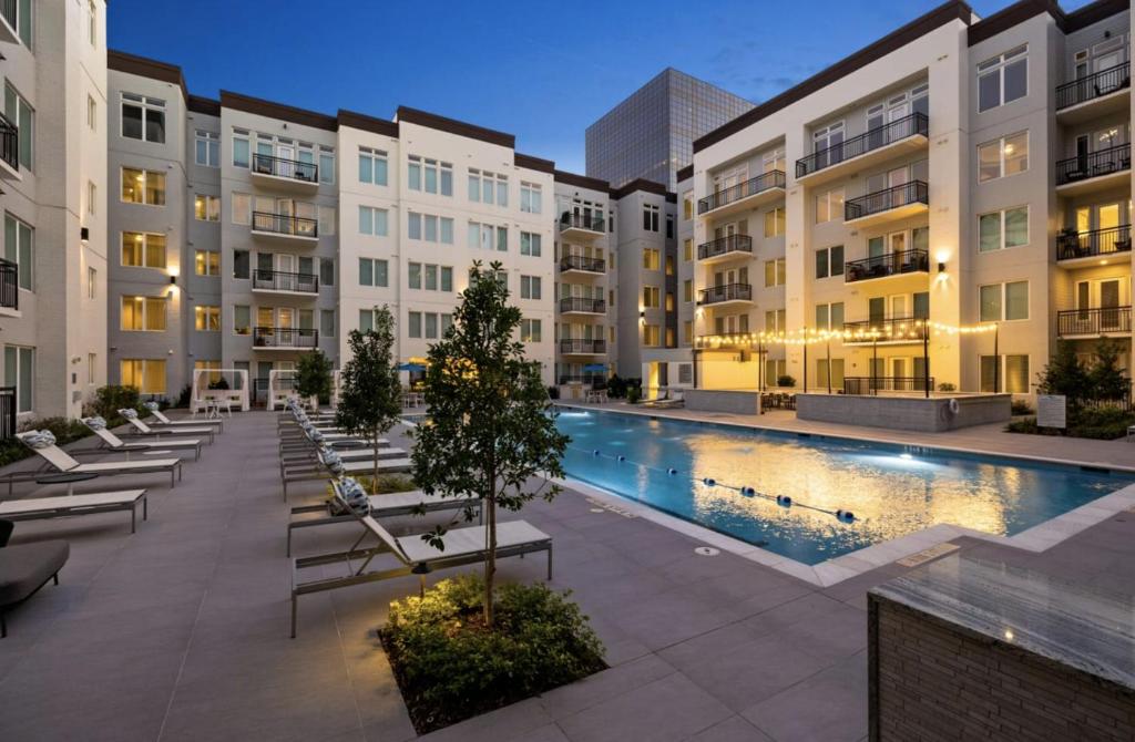 an apartment complex with a swimming pool and buildings at Resort-Style Apartments near The Galleria in Houston