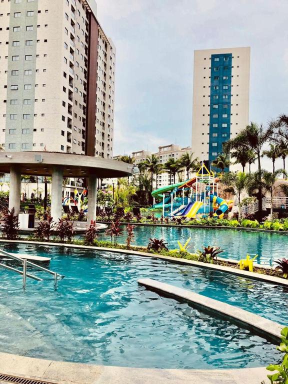 a large swimming pool in a city with tall buildings at Salinas Premium Resort in Salinópolis