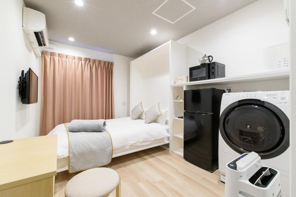 Postel nebo postele na pokoji v ubytování JP INN Kyoto Ekimae Izutsucho