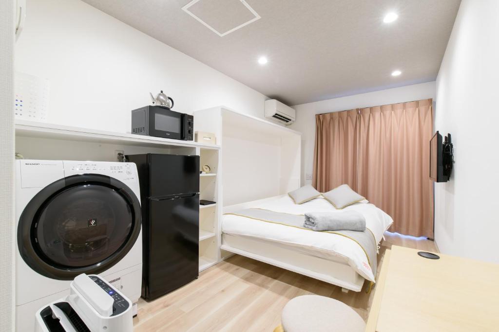 Postel nebo postele na pokoji v ubytování JP INN Kyoto Ekimae Izutsucho