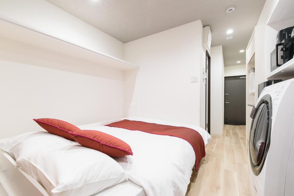 Postel nebo postele na pokoji v ubytování JP INN Kyoto Ekimae Izutsucho