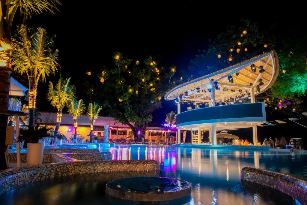 a pool at night with a roller coaster at Arkbar Beach Club in Chaweng