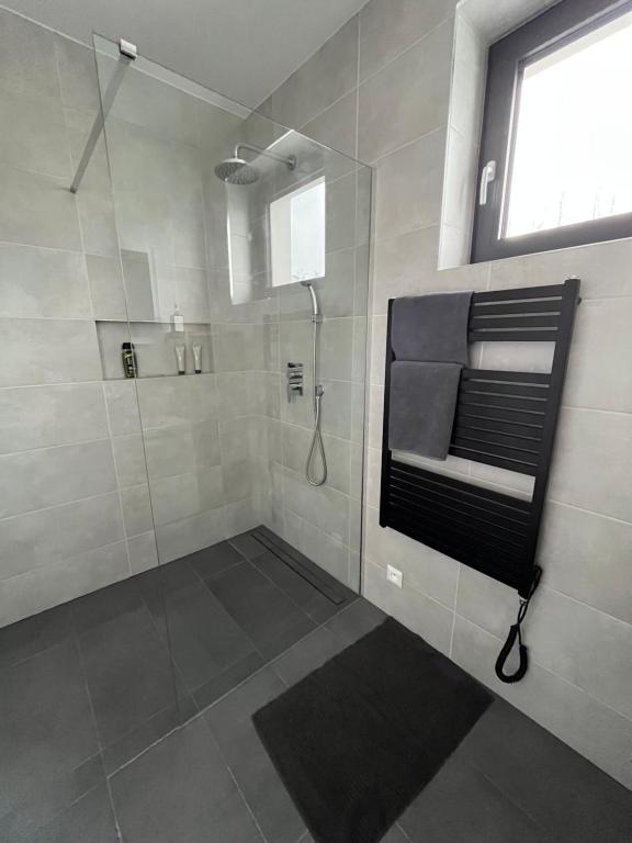 a bathroom with a walk in shower and a shower at Golf Villa Stella s bazénom in Šajdíkove Humence