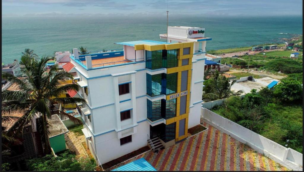 a building with a view of the ocean at Rosan Heritage - A Beach Villa in Kanyakumari