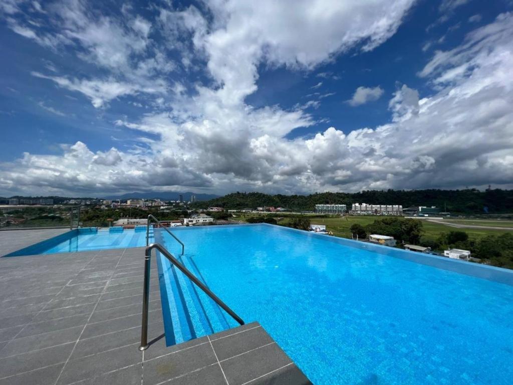 a large swimming pool on the roof of a building at Nilam Residence ARU SUITES Sea View 2BR INFINITY POOL in Kota Kinabalu