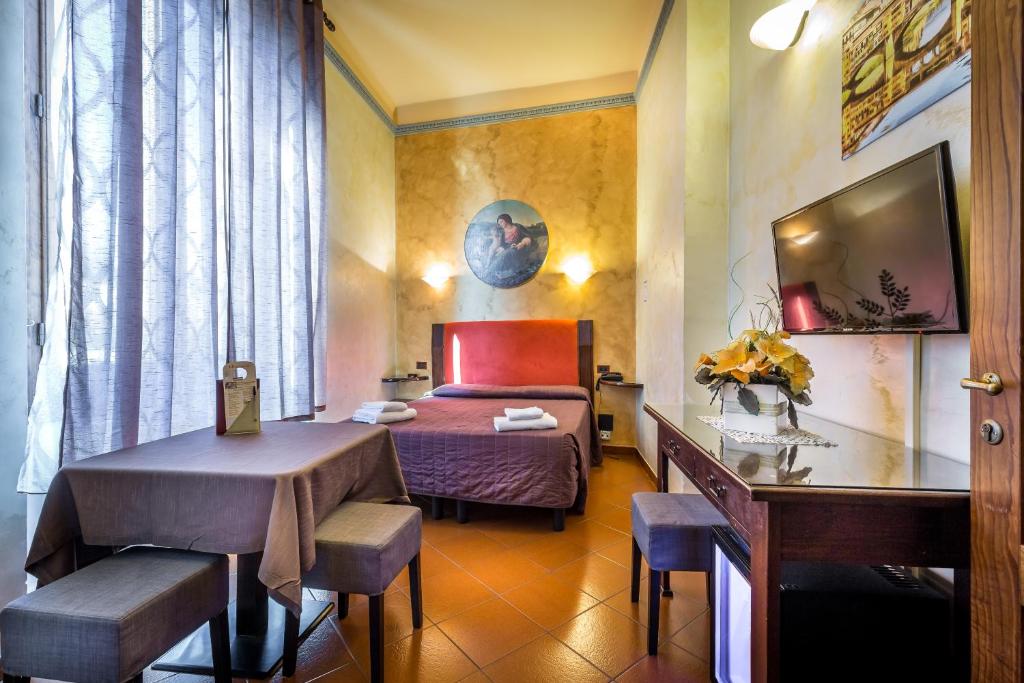 a hotel room with a bed and a table at Tuscany Love DELLE TELE-FIRENZE in Florence