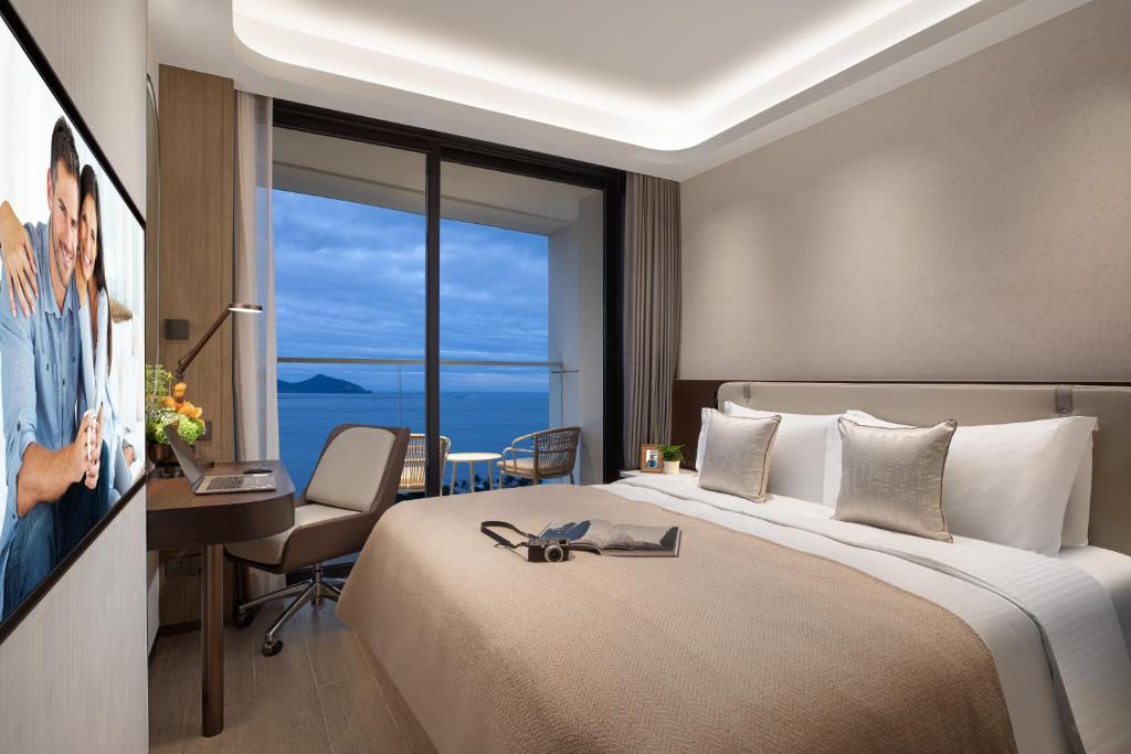 Postel nebo postele na pokoji v ubytování Ascott Dadonghai Bay Sanya