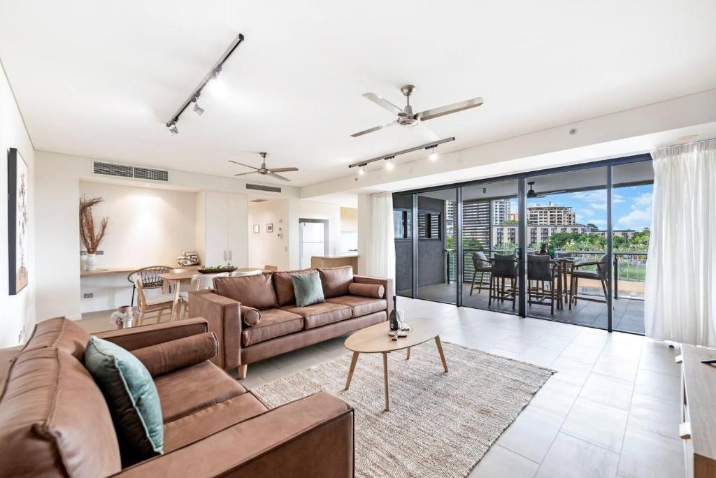 a living room with a couch and a table at 'Lady of the Lagoon' Spacious Waterfront Luxury in Darwin