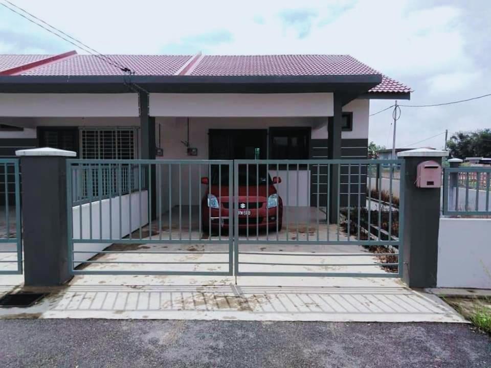 a house with a gate in front of it at Homestay baitijannati in Pasir Mas