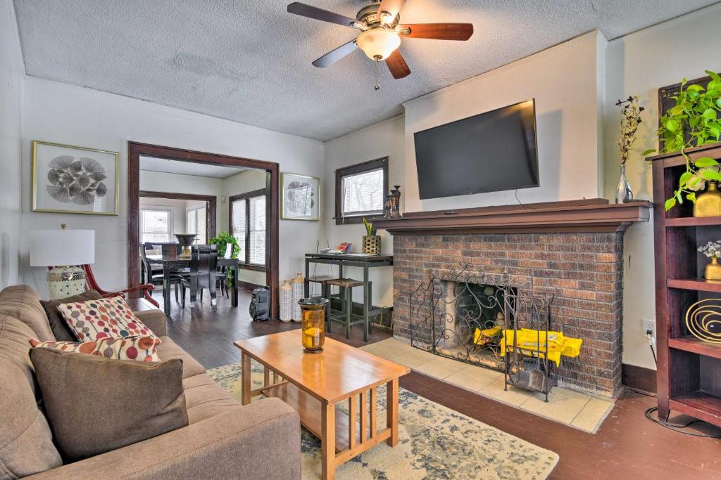 a living room with a fireplace and a tv at Awesome Detroit Apartment Less Than 3 Mi to Midtown! in Detroit