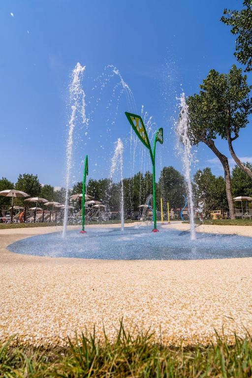 a water park with two fountains in the middle at Club del Sole Rimini Family Resort in Rimini