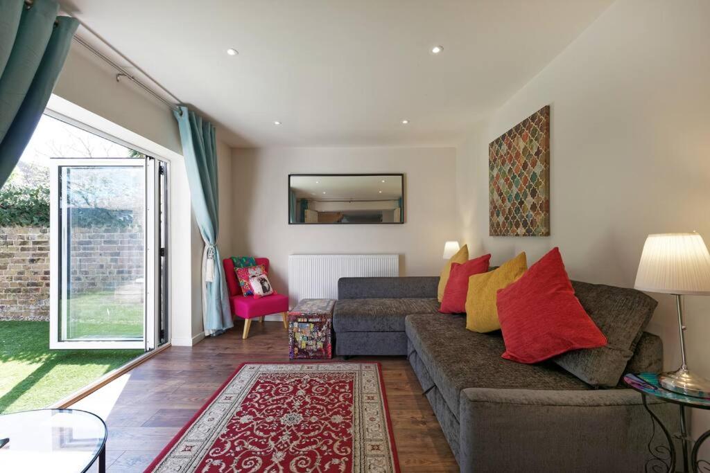 a living room with a couch and a table at Garden Oasis in Margate