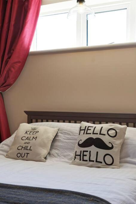 a bed with two pillows on it with a window at Garden Oasis in Margate