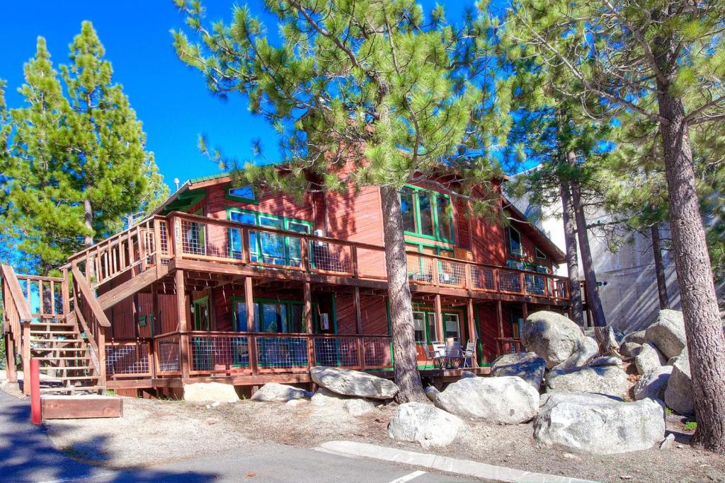 a large wooden house with trees and rocks at Tahoe Olympic condo in Stateline