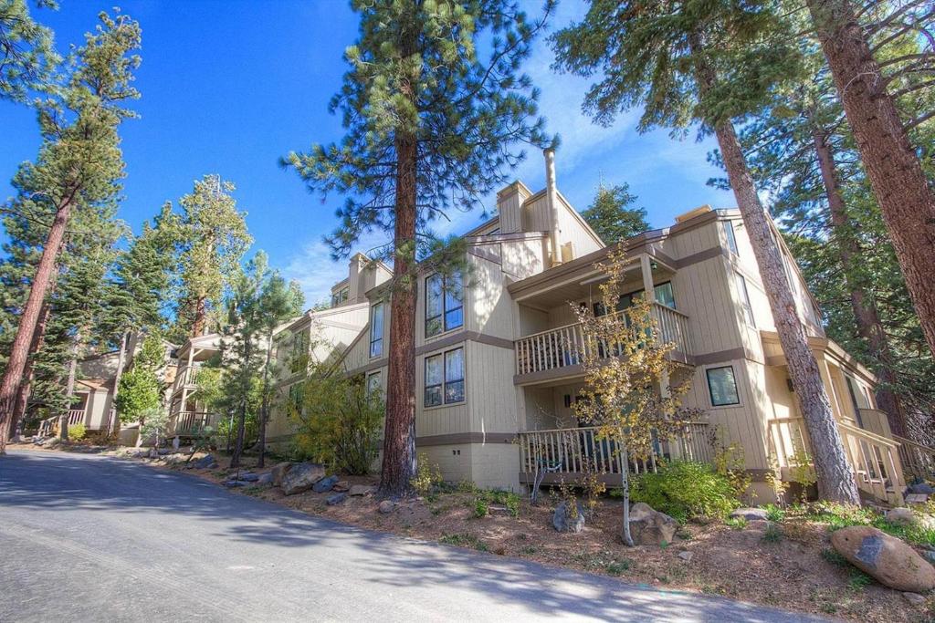 a large house with trees in front of a street at Forest View Townhouse home in Kings Beach
