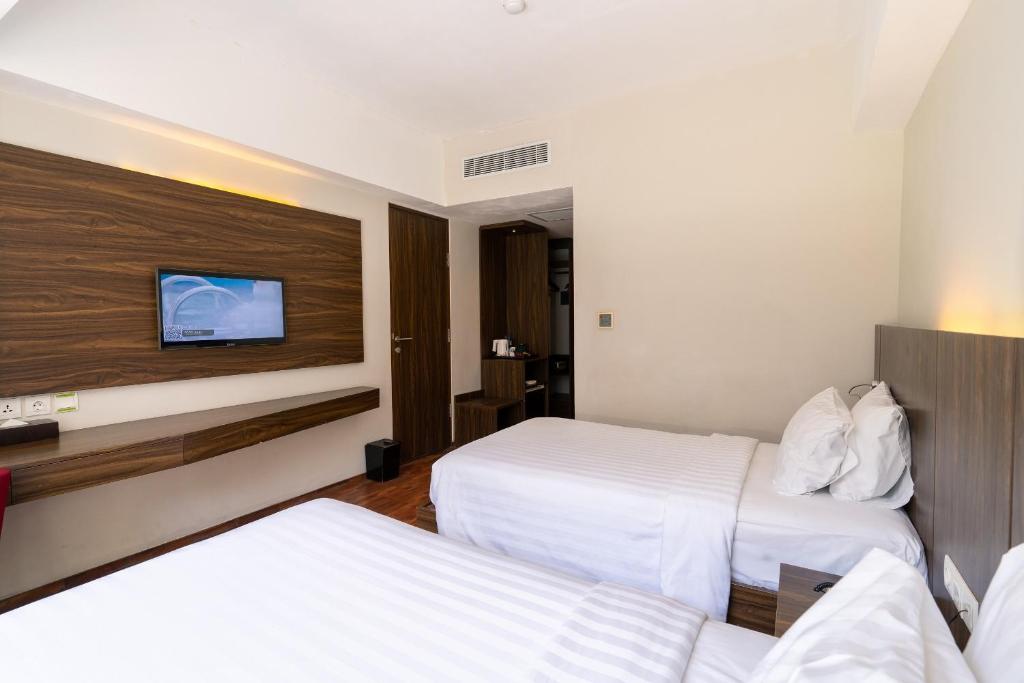 Postel nebo postele na pokoji v ubytování The Bene Hotel