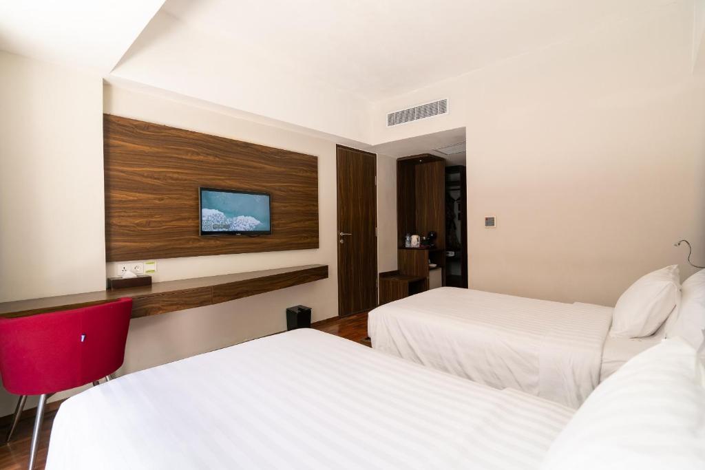 Postel nebo postele na pokoji v ubytování The Bene Hotel