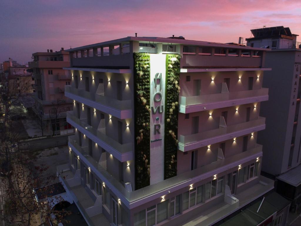 a building with a vertical garden on the side of it at Residence Flow-R in Riccione