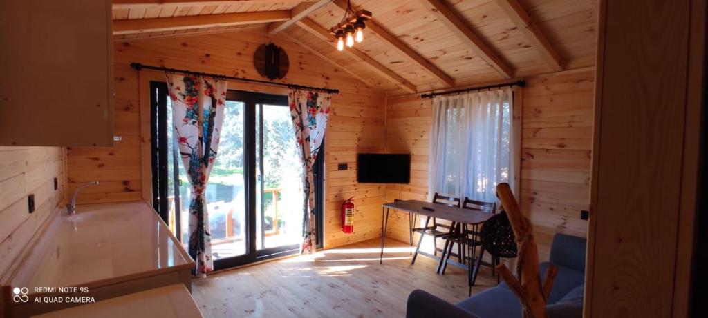 a room with a desk in a log cabin at olive garden bungalow in Fethiye
