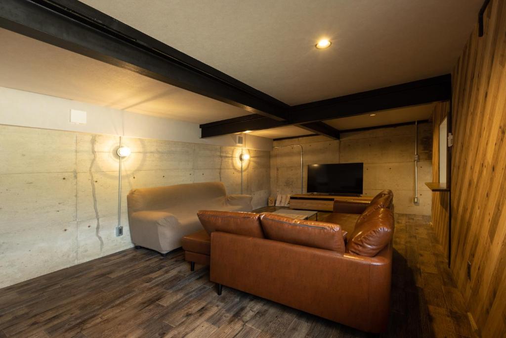 a living room with a couch and a bed at The minpark in Dazaifu