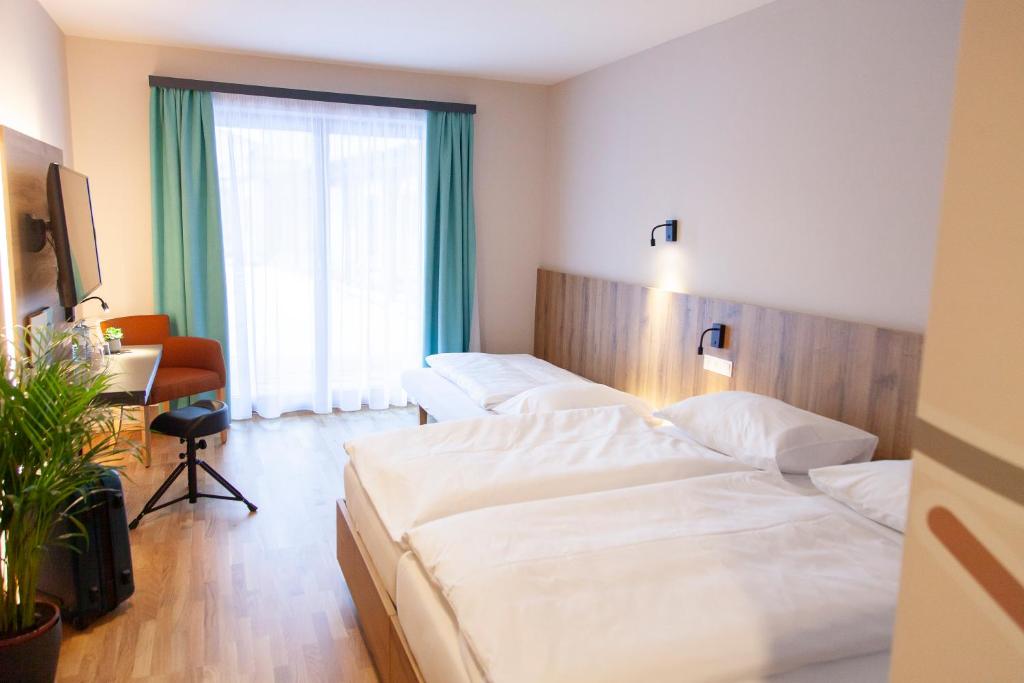 Postel nebo postele na pokoji v ubytování JUFA Hotel Erlaufsee