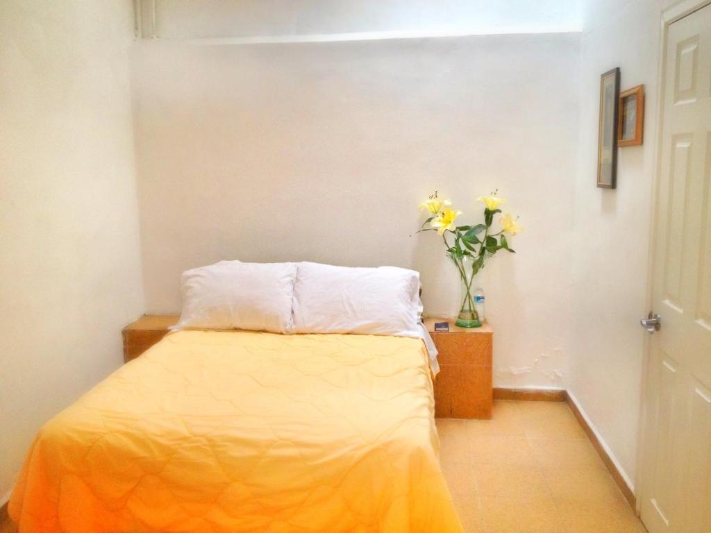 Postel nebo postele na pokoji v ubytování Hotel RJ Querétaro