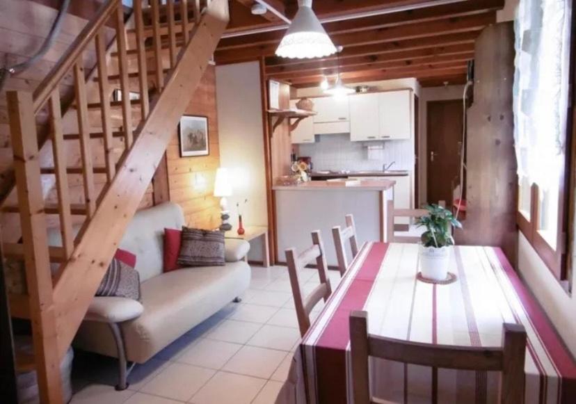 ein Wohnzimmer mit einem Esstisch und einer Küche in der Unterkunft Belle de jour in Mézos