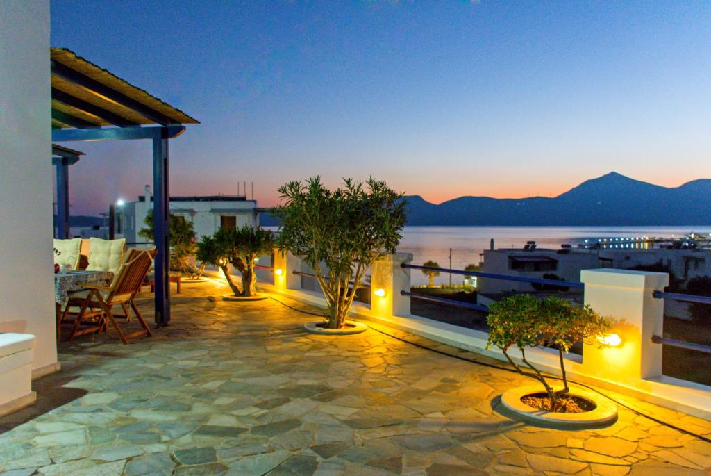 a rooftop patio with trees and a view of the water at AEGEA MILOS in Adamas