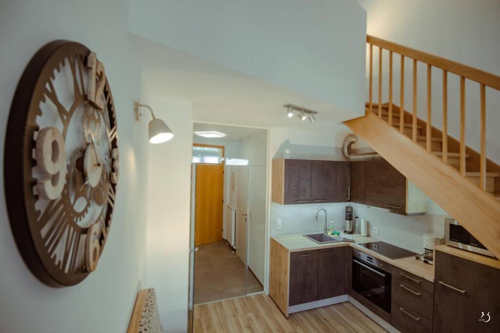 a kitchen with a large clock on the wall at Mein Appartement Nr.9 in Planneralm