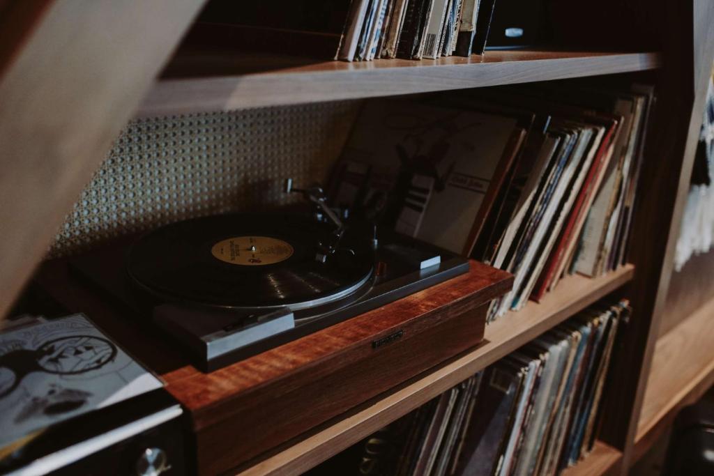 a record shelf with a sink and a record player at Thompson Nashville, by Hyatt in Nashville