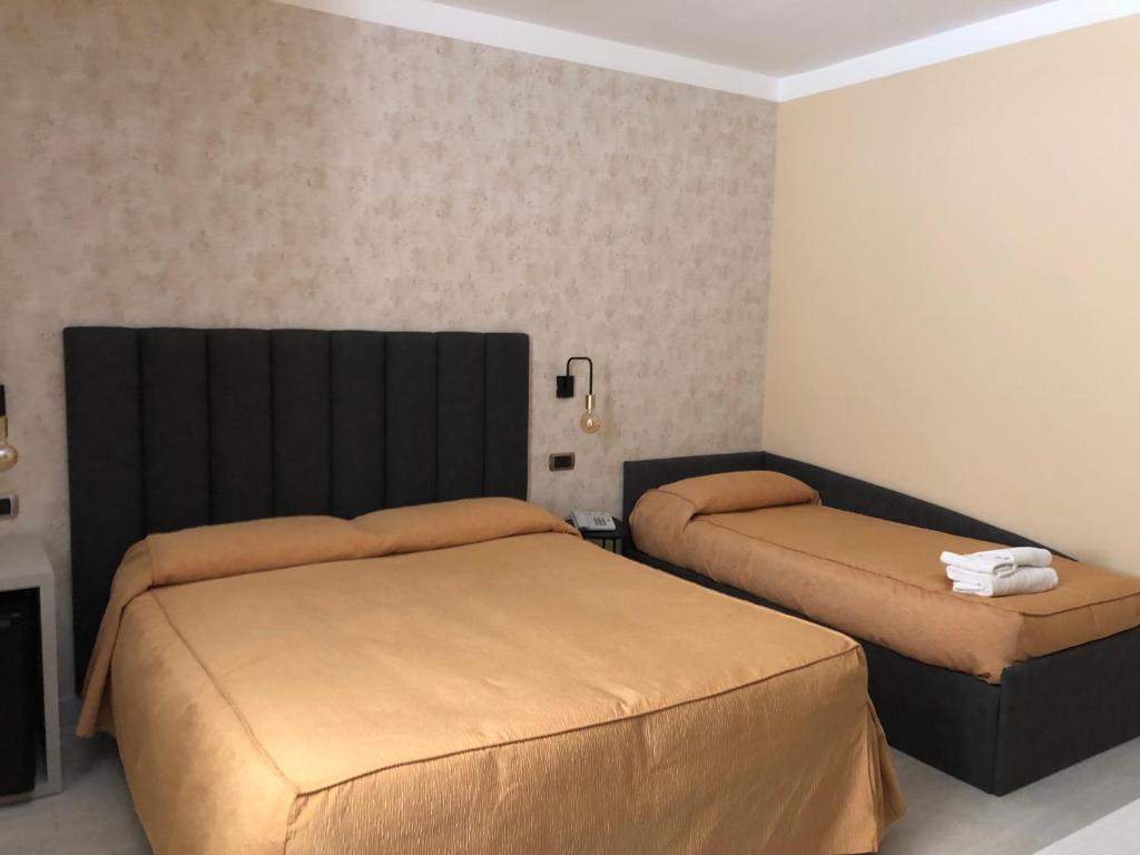 Postel nebo postele na pokoji v ubytování Hotel Tirrenia
