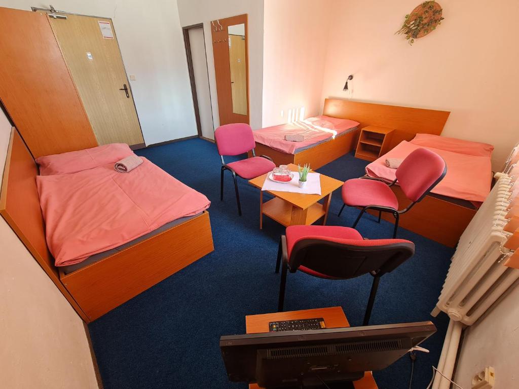 Postel nebo postele na pokoji v ubytování Penzion Olympia