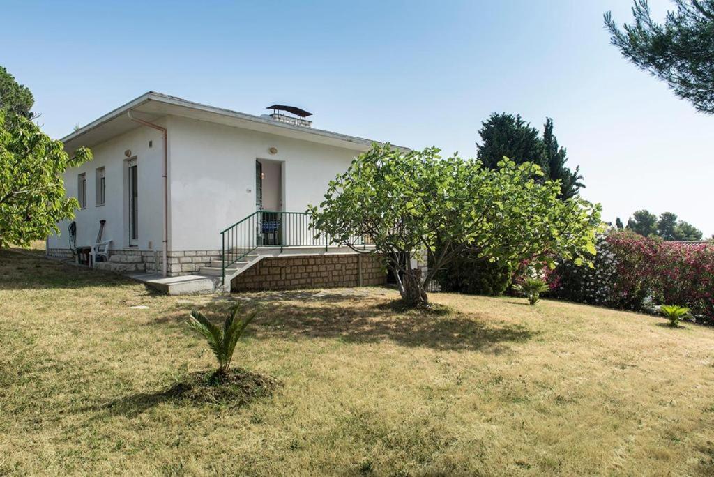 een wit huis met een tuin met bomen bij N122 - Numana, villa singola con giardino e vista mare in Numana