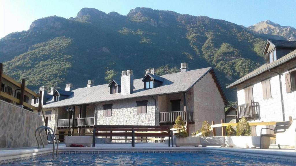 un edificio con piscina frente a una montaña en Apartamento Nevados 2620 en Anciles
