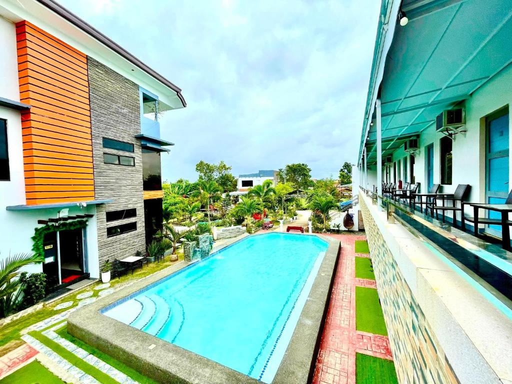 a swimming pool on the side of a building at Little Rock Cebu in Mactan