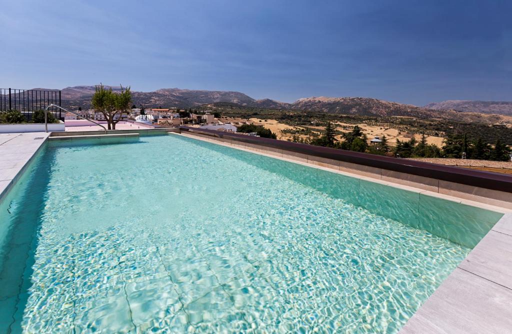 a swimming pool with a view of the mountains at Catalonia Ronda in Ronda
