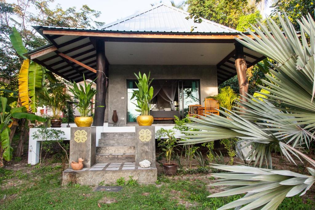 a small house in a garden with plants at Deep Dream Chalet in Hinkong