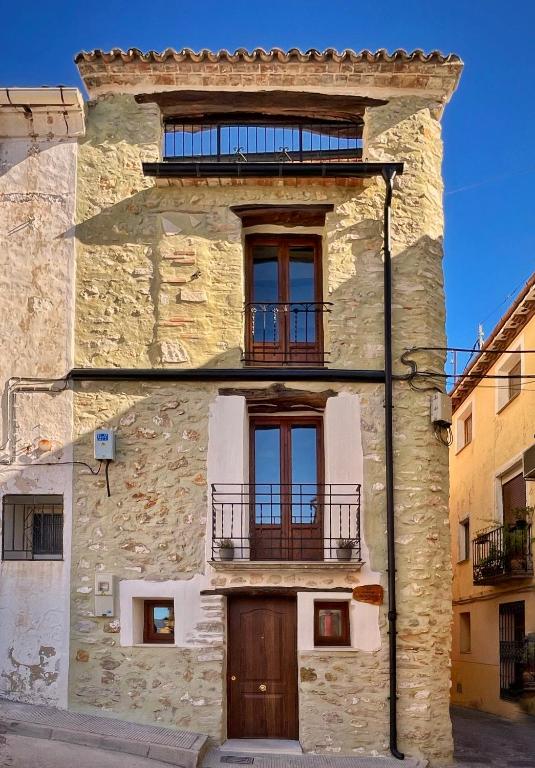 a stone building with a balcony on top of it at Ca tia Teresa in Planes