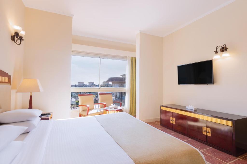 A bed or beds in a room at Coral Sea Beach and Aqua Park
