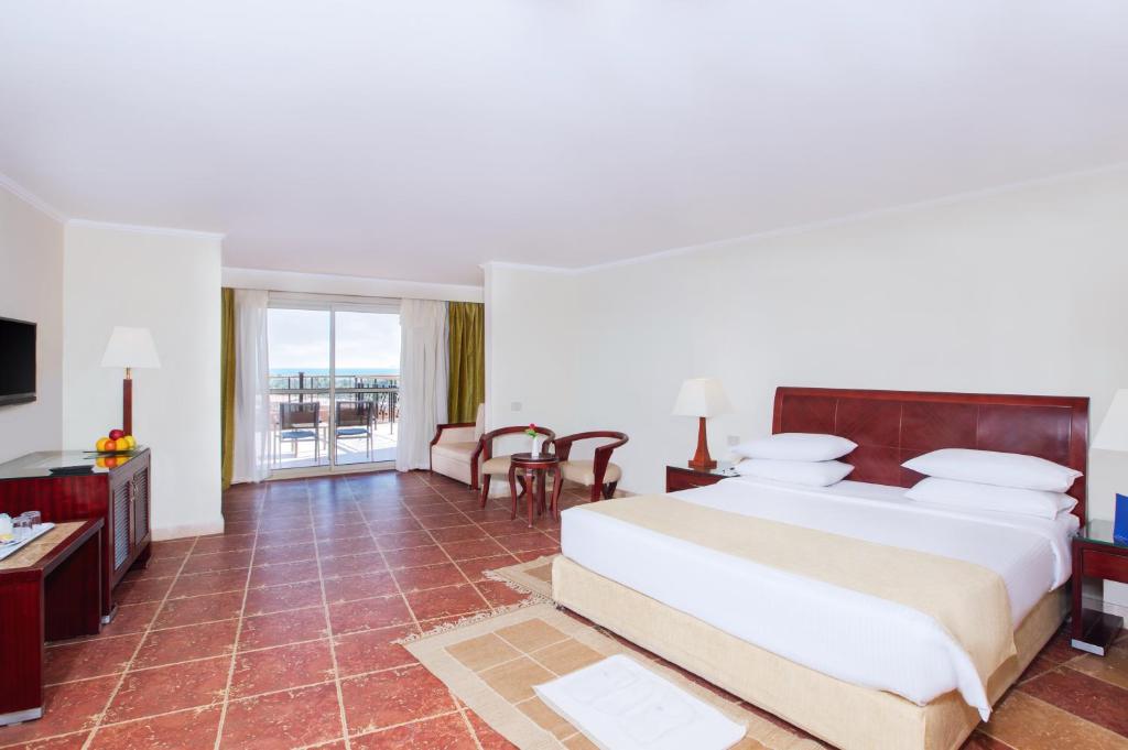 A bed or beds in a room at Coral Sea Beach and Aqua Park