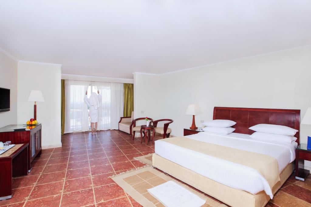 A bed or beds in a room at Coral Sea Beach and Aqua Park