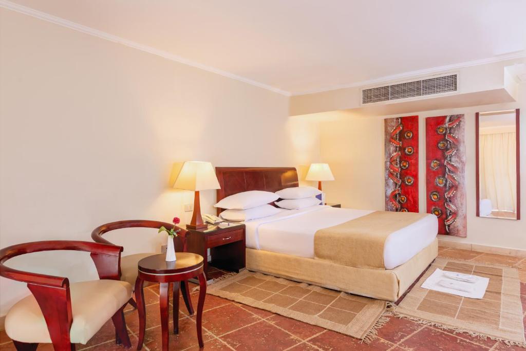 A bed or beds in a room at Coral Sea Beach and Aqua Park