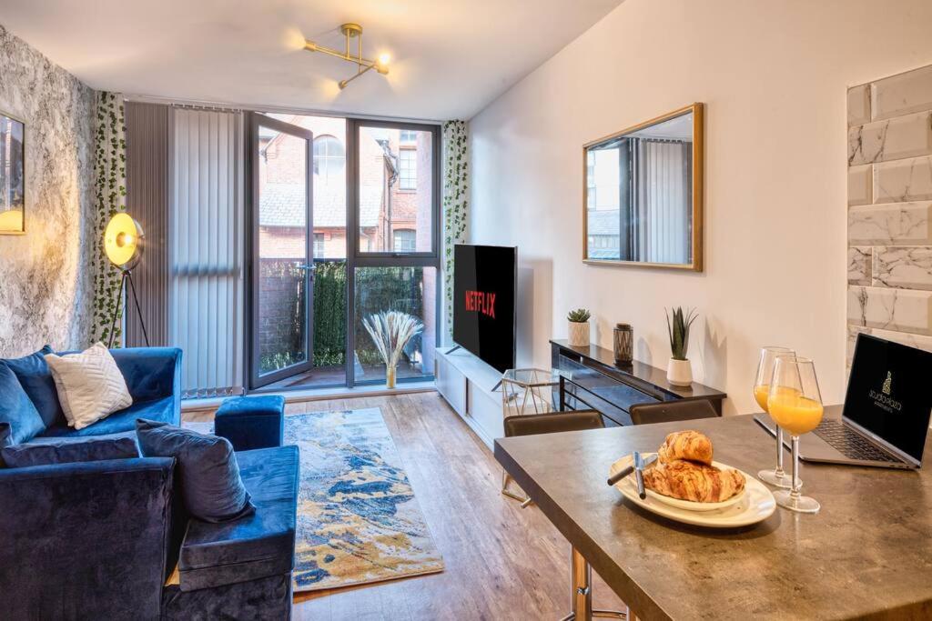ein Wohnzimmer mit einem Tisch und einem Glas Wein in der Unterkunft City Centre Apartment - Ideal for longer stays in Manchester