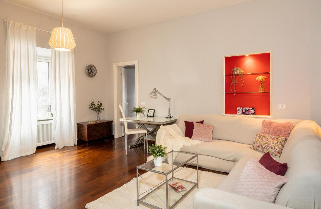 a living room with a white couch and a table at 8 HOME in Rome