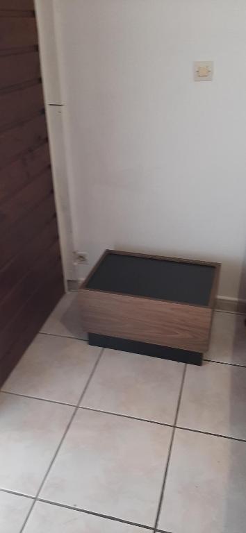 a room with a wooden box on the floor at Meublé de la vallée in Saint-Pierre