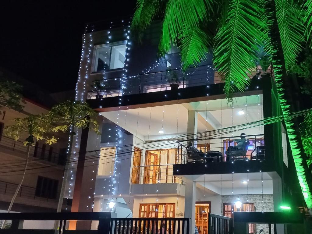 a large building with a balcony at night at Pibo Homestay in Port Blair